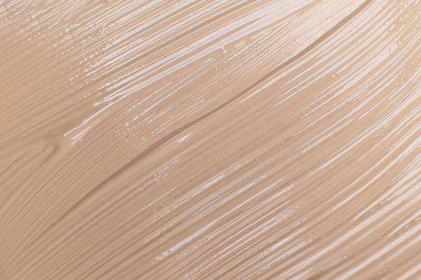 Beige cosmetic foundation cream background, texture - Zdjęcie, obraz