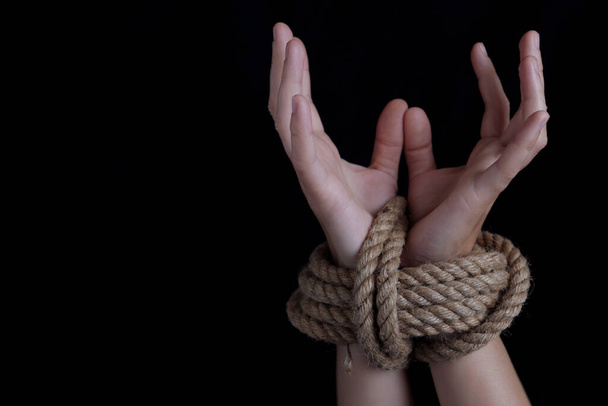 Woman with hands tied with rope, concept of violence, woman's rights - Foto, Imagen