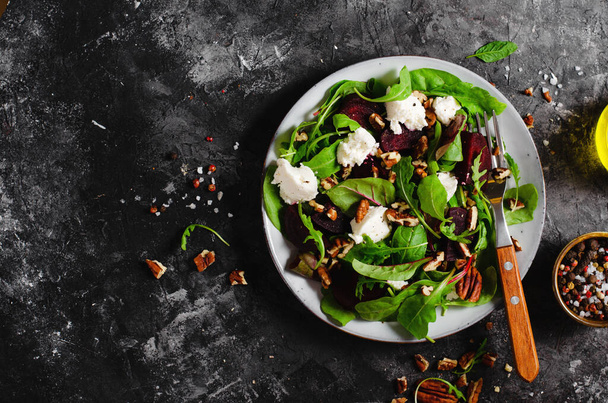 Fresh Salad with Beetroot, Feta Cheese, and Pecans, Vegetarian Meal on Dark Background - Fotó, kép