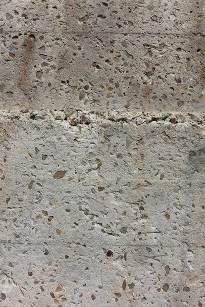 Fragment of a wall with little rocks. Grunge texture close up. Old damaged stone wall background. Easily add depth and organic texture to your designs. - Foto, Bild