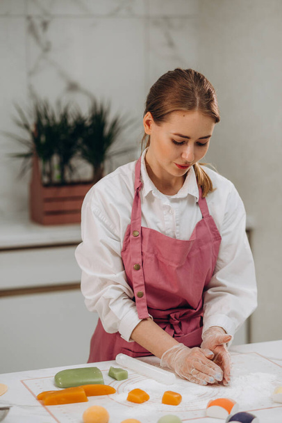 a woman confectioner in the kitchen prepares mochi dessert. - Φωτογραφία, εικόνα