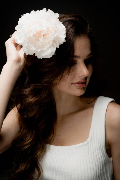 portrait of fashionable young woman posing in studio with flower - Φωτογραφία, εικόνα