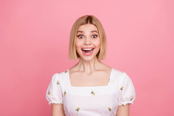 Photo of funny excited young girl looking camera with open mouth good news wear white shirt isolated pink color background. - Fotó, kép