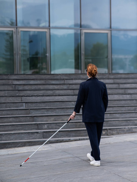 Blind businesswoman walking with tactile cane to business center - Фото, зображення