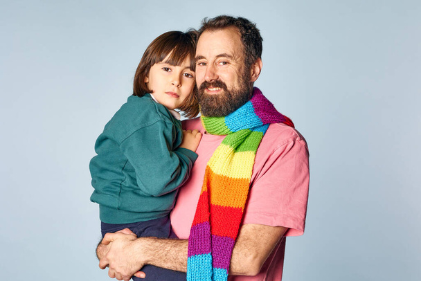 portrait of divorced lgbt father with his daughter in studio on isolated background. happy family relationship - Фото, зображення