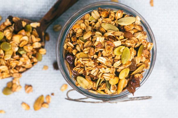 Granola with raisins and pumpkin seeds in a jar - Photo, image