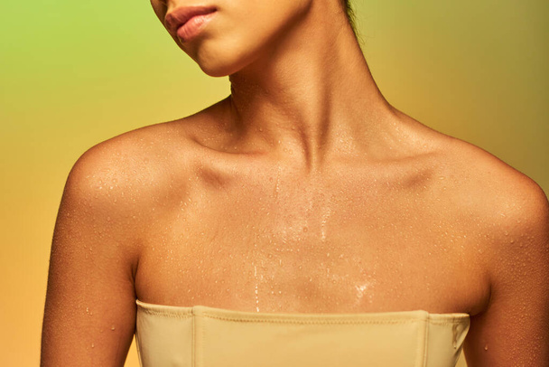 hydration, cropped view of young woman with bare shoulders and wet body posing on gradient background, skincare campaign, beauty model, glowing skin, green background, natural beauty  - Photo, Image