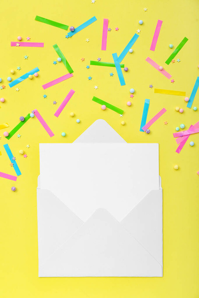 Blank card with confetti and sprinkles on yellow background - 写真・画像