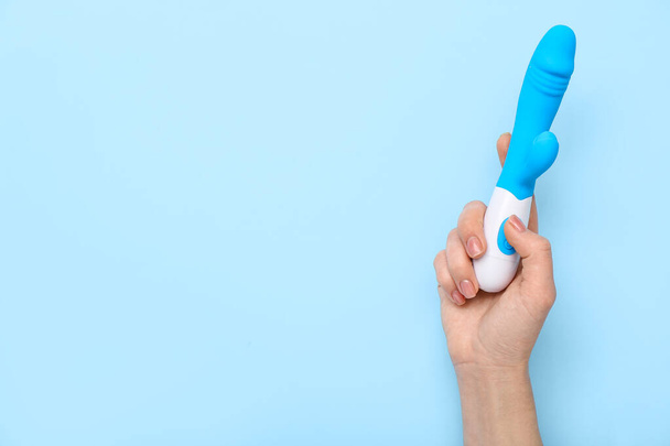 Woman with vibrator on blue background - Foto, Imagen