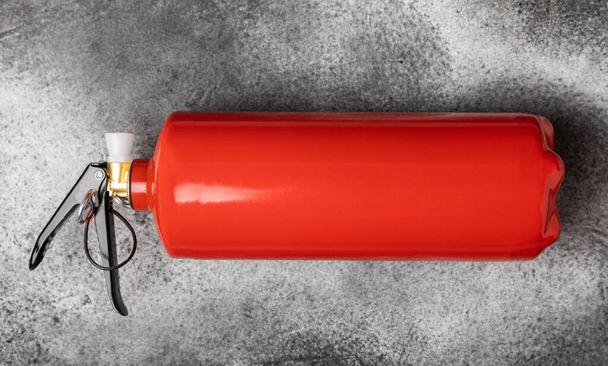 Fire extinguisher on a black marble background. Fire protection, home fire extinguisher. home security concept. Place for text. Copy space.banner - Foto, Imagem
