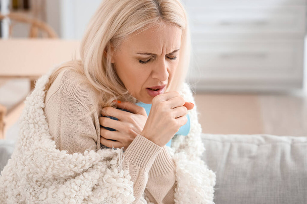 Ill mature woman coughing at home, closeup - Foto, imagen