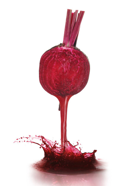 Pouring freshly squeezed juice from beetroot on white background - Foto, Bild