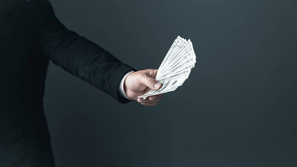business man holding 100 cash bills Dollar currency, investment finance concept, success in business. - Φωτογραφία, εικόνα