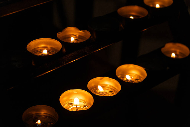 Burning candles in a Catholic Christian church. - Photo, image