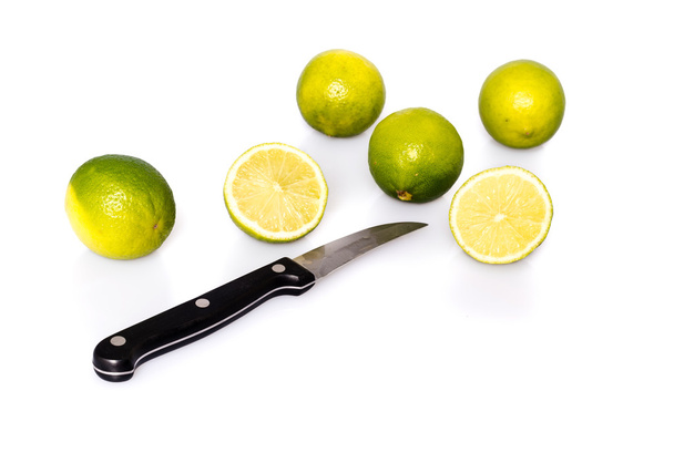 Knife and green fresh limes - Photo, Image