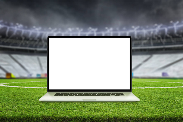 Laptop mockup on football field. Stadium stands in background. Isolated screen for app or web page promotion - Fotó, kép
