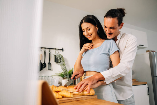 Healthy lovers cooking food in kitchen, Happy young couple spending time together at home, Husband and wife relaxing and resting at modern house, Family and lovers with hobby lifestyle - Fotó, kép