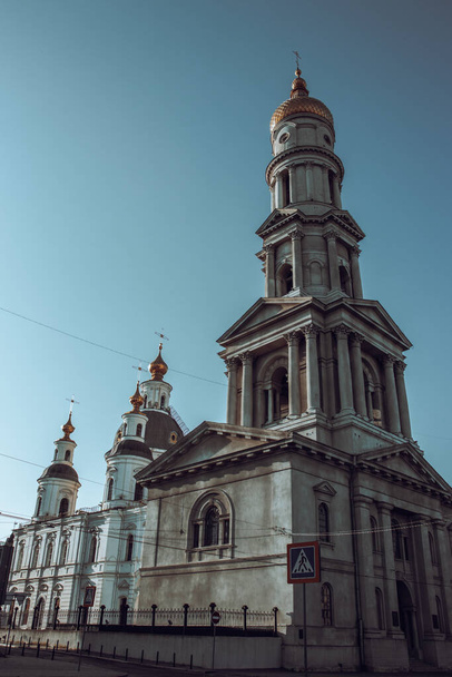 The old historical center of Kharkiv morning photo. Church architecture in summer, Ukraine. Urban city life. High quality picture for wallpaper, travel blog. - Photo, Image