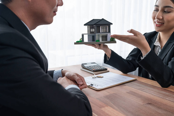 Client and real estate agent review loan contract, discussing term, interest rate, and property ownership. Analyze legal document and thoroughly read agreement before making decision. Jubilant - Photo, Image