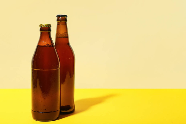 Bottles of cold beer on yellow background - Foto, Imagem