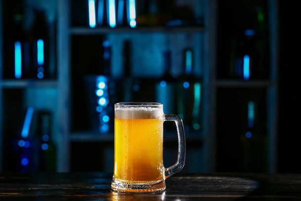 Taza de cerveza fresca en la mesa en el bar - Foto, imagen