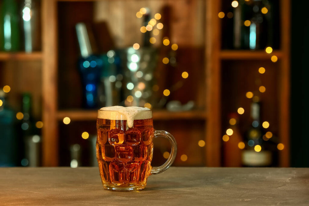 Mug of fresh beer on table in bar - Photo, Image