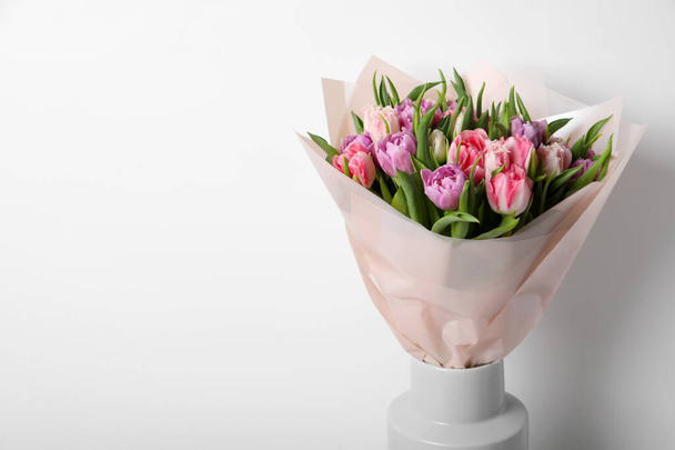 Vase with bouquet of beautiful tulips on white background. Space for text - Photo, Image