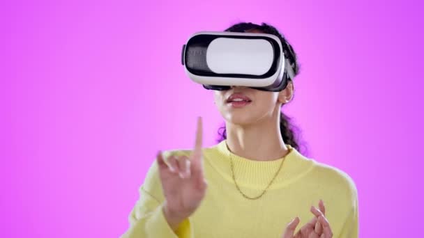 Vr, touch and woman in 3d metaverse in studio isolated on a purple background. Virtual reality, technology and person scroll for futuristic experience, typing and click ux for gaming in cyber fantasy. - Footage, Video
