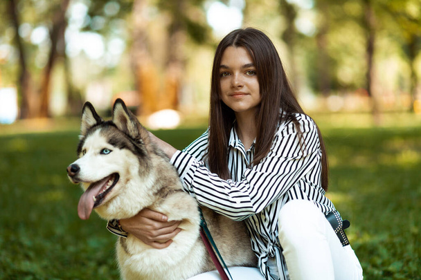 Clever husky. Portrait of owner and pet. Dog training school. - Photo, Image