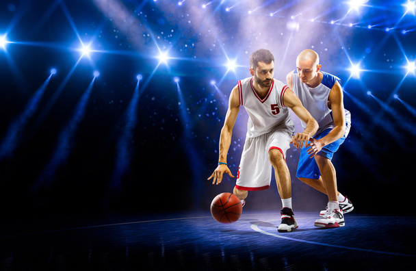 Two basketball players in spotlights - Foto, Imagen