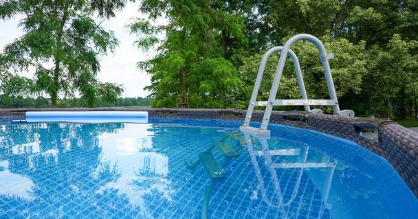 Garden pool. Swimming pool in the garden. Swimming in pool. Hot summer holidays, vacations. - Photo, Image