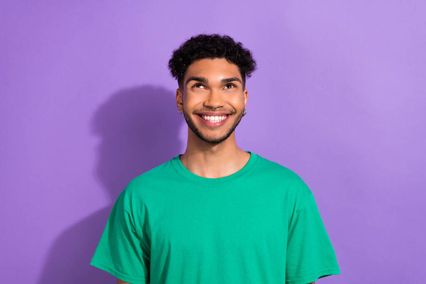 Portrait of handsome youngster guy white teeth smile look up wonder wear hipster clothes isolated purple pastel color background. - 写真・画像