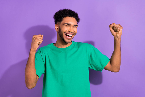 Photo of funny cool nice multinational guy excited lottery jackpot winning wear green shirt isolated purple pastel color background. - Foto, imagen