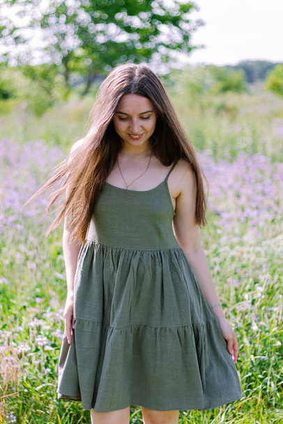 Portrait of beautiful happy woman on the background of flowering field  - Valokuva, kuva
