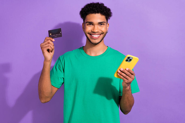 Photo of cool attractive man wear green t-shirt online shopping modern gadget isolated purple color background. - Φωτογραφία, εικόνα