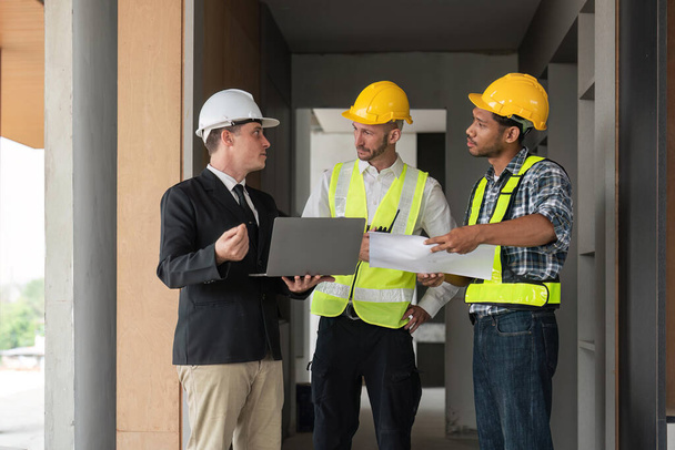 Professional construction engineers team using blueprint of project plan brainstorming and working together at construction building, Architecture and building construction concept. - Foto, Imagen