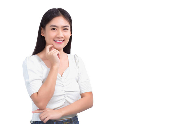 Portrait Asian beautiful girl in white shirt touches her face and smiles on white background studio. - Photo, image