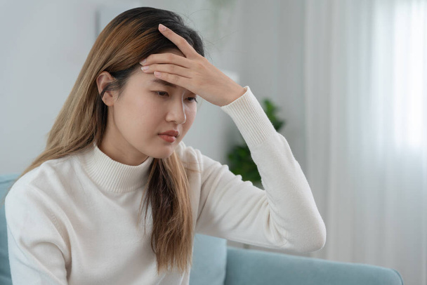 Headache, female having migraine pain, bad health, Asian woman feeling stress and headache, Office syndrome, sad tired touching forehead having migraine or depression, irritated girl, sadness grief - Foto, Bild