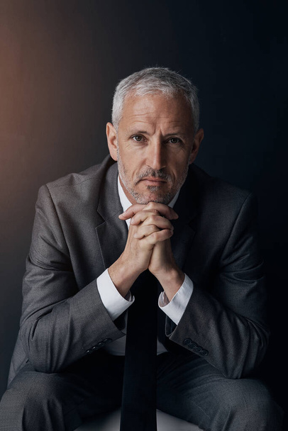 Serious portrait of senior lawyer, confident businessman or legal advisor in suit on dark background in studio. Boss, ceo or business owner with pride, senior executive director or law firm attorney - Photo, Image