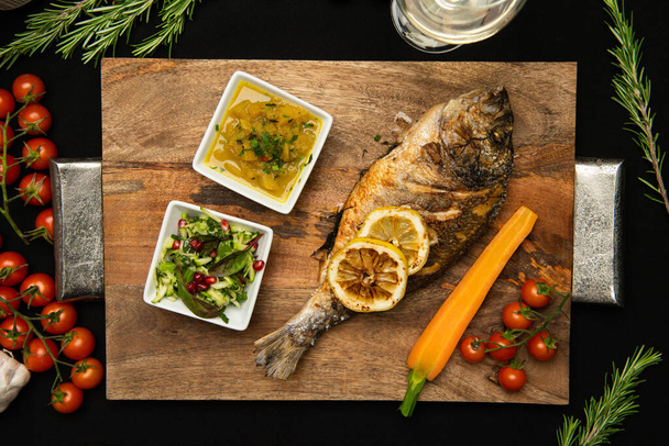Grilled Bream fish on wooden board. Healthy food. - Fotoğraf, Görsel