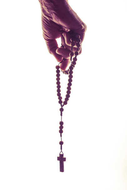Catholic Wooden Rosary in Human Hand Isolated on White Background. Prayer Concept. - Valokuva, kuva