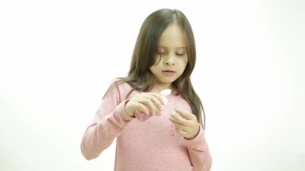 Young girl taking medicine in syrup form and making expressions - Záběry, video