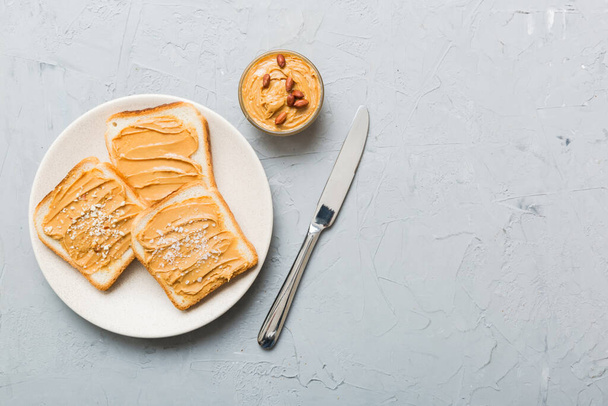Peanut butter sandwiches or toasts on light table background.Breakfast. Vegetarian food. American cuisine top view vith copy space. - Foto, afbeelding