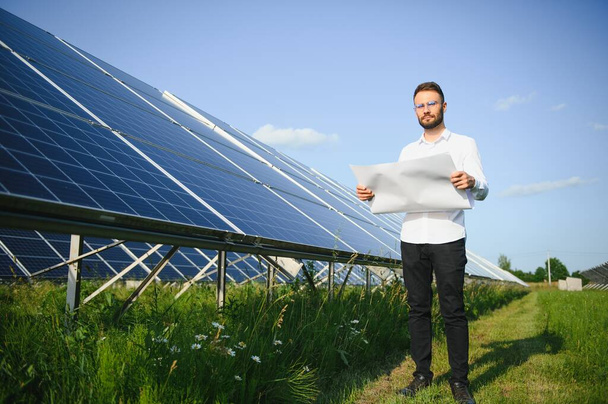 Young architect standing by solar panels. - Photo, Image