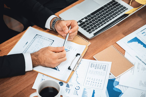 Diverse group of business analyst team analyzing financial data report paper on office table. Chart and graph dashboard by business intelligence analysis for strategic marketing planning Meticulous - Foto, immagini