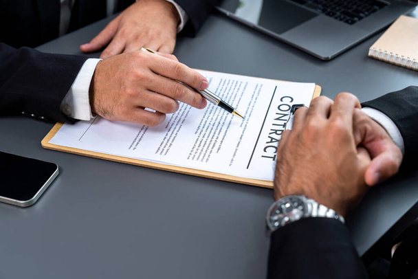 Closeup hand signing contract document with pen, sealing business deal with signature. Businesspeople finalizing business agreement by writing down signature on contract paper. Fervent - 写真・画像