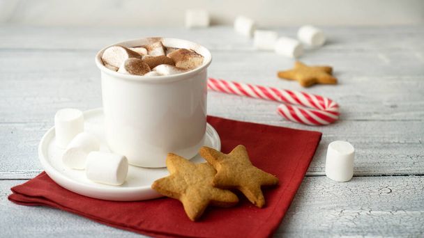 Shaped ginger cookies with hot cocoa. Traditional sweet New Year's drink with spicy cakes to treat Santa Claus and children - Foto, immagini