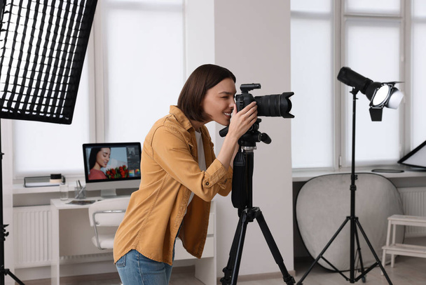 Professional photographer taking picture in modern photo studio - Foto, afbeelding