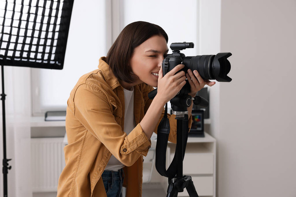 Professional photographer taking picture in modern photo studio - Foto, imagen