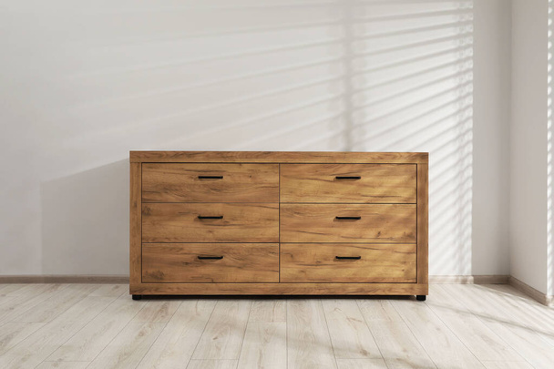 Wooden stylish chest of drawers near white wall indoors - Фото, зображення